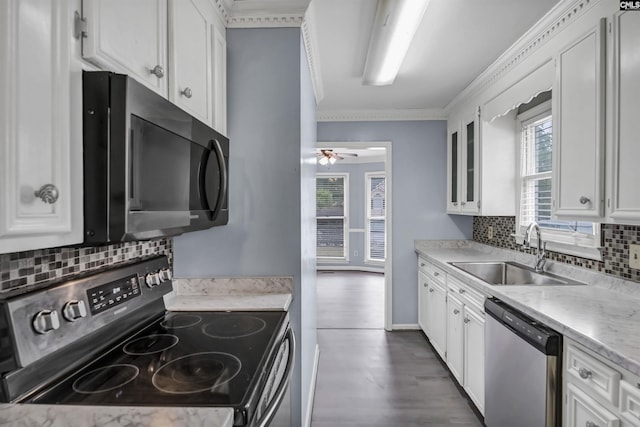 105 Golden Pond Dr, Lexington, SC 29073 - kitchen with stainless steel appliances, a sink, healthy amount of natural light, white cabinets, and ornamental molding