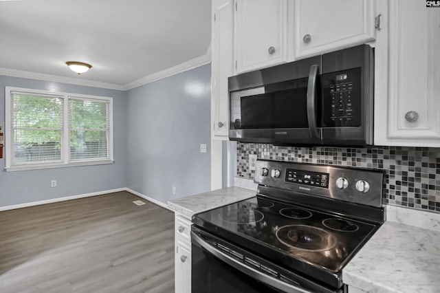 105 Golden Pond Dr, Lexington, SC 29073 - kitchen with range with electric stovetop, ornamental molding, white cabinets, and backsplash