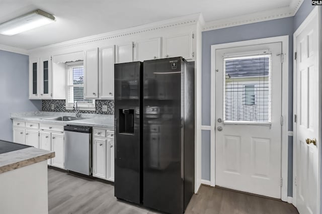 105 Golden Pond Dr, Lexington, SC 29073 - kitchen featuring black refrigerator with ice dispenser, stainless steel dishwasher, light wood-type flooring, a sink, and ornamental molding