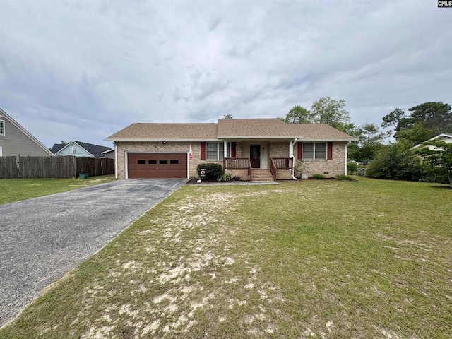 ranch-style home with covered porch, an attached garage, driveway, brick siding, and roof with shingles