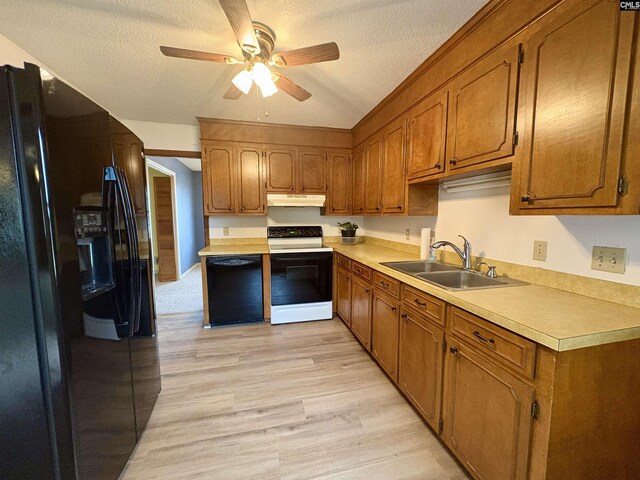 kitchen with black refrigerator with ice dispenser, range with electric cooktop, a sink, under cabinet range hood, and ceiling fan