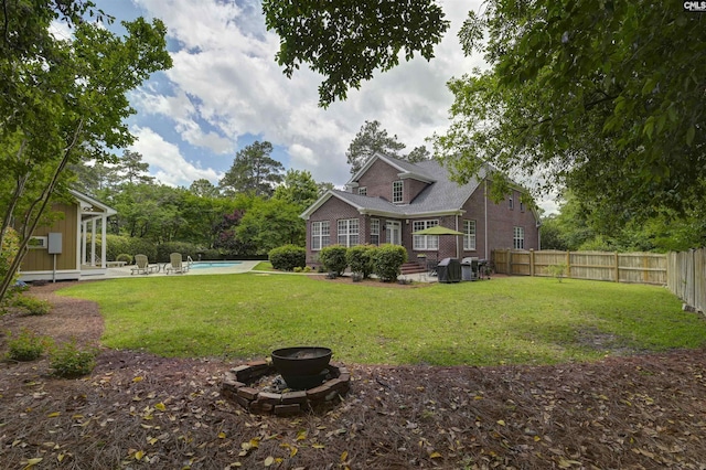 5102 Circle Dr, Columbia, SC 29206 - rear view of house with a fire pit, brick siding, and a patio