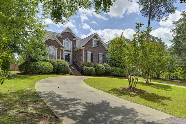 5102 Circle Dr, Columbia, SC 29206 - colonial home with brick siding, curved driveway, and a front lawn