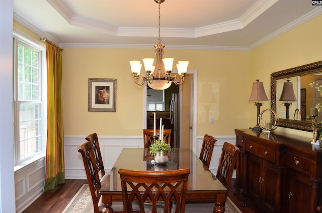 5102 Circle Dr, Columbia, SC 29206 - dining space featuring a chandelier, dark wood finished floors, a decorative wall, a raised ceiling, and a wainscoted wall
