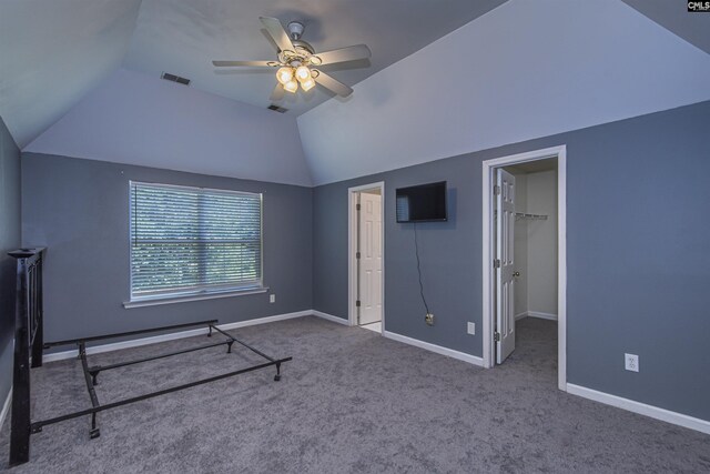 409 Waterville Dr, Columbia, SC 29229 - unfurnished bedroom with lofted ceiling, carpet floors, baseboards, a ceiling fan, and a walk in closet