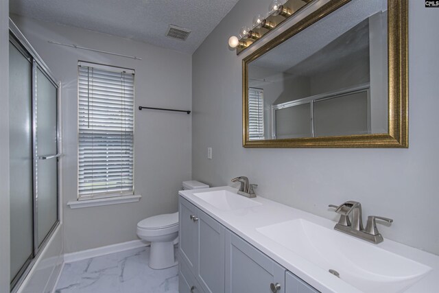 409 Waterville Dr, Columbia, SC 29229 - bathroom featuring toilet, baseboards, double vanity, marble finish floors, and a textured ceiling