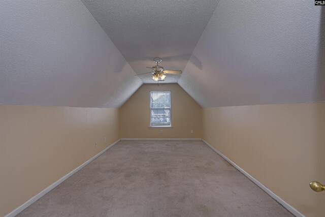 409 Waterville Dr, Columbia, SC 29229 - bonus room featuring a textured ceiling, ceiling fan, baseboards, vaulted ceiling, and light colored carpet