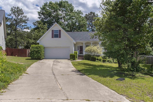 traditional-style house featuring concrete driveway, covered porch, and a garage