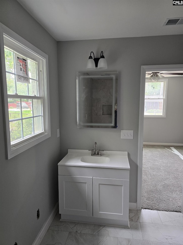 2009 Woodfield Dr, Columbia, SC 29223 - bathroom with marble look tile flooring, baseboards, healthy amount of natural light, and vanity