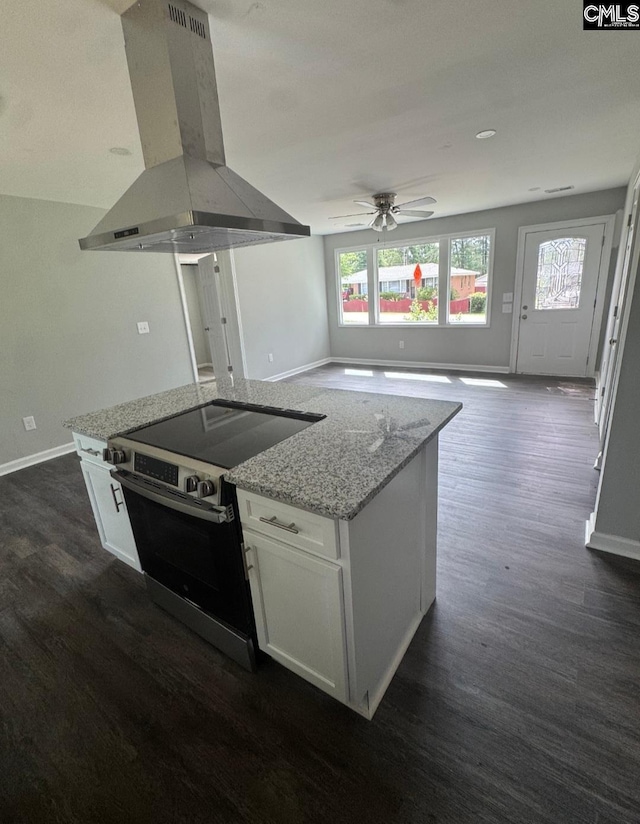 2009 Woodfield Dr, Columbia, SC 29223 - kitchen featuring island exhaust hood, electric stove, a ceiling fan, dark wood-style floors, and white cabinetry