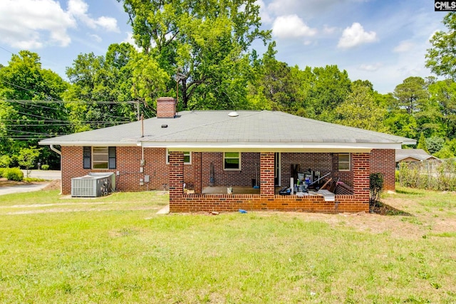 120 Mcrae St, Columbia, SC 29203 - back of property featuring a chimney, a yard, cooling unit, and brick siding