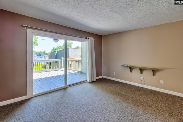 carpeted empty room featuring baseboards and a textured ceiling
