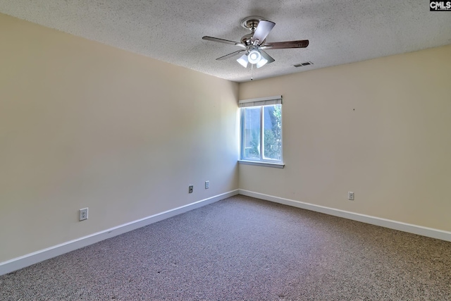 spare room with a textured ceiling, ceiling fan, carpet floors, and baseboards