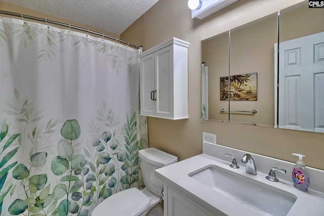 bathroom with toilet, vanity, a textured ceiling, and a shower with curtain