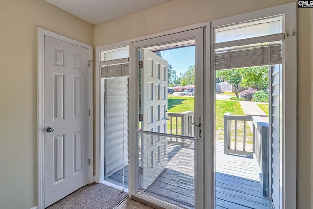 entryway with plenty of natural light and carpet