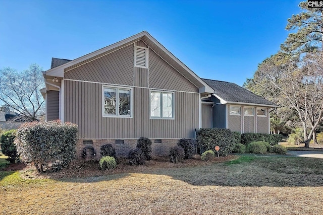 view of side of property featuring crawl space and a lawn