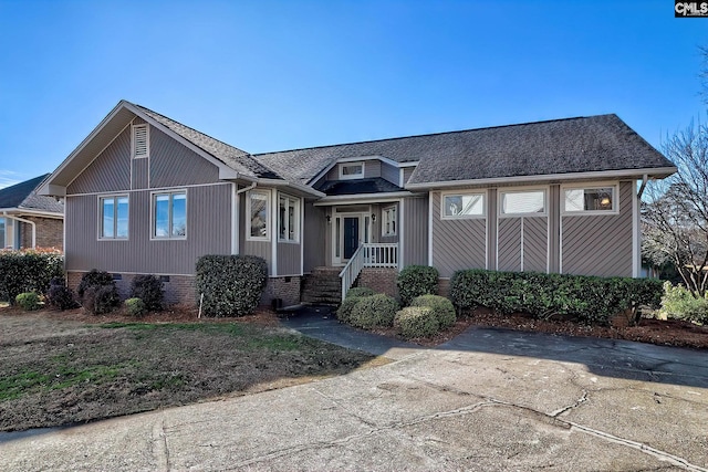 view of front of home featuring crawl space and a shingled roof