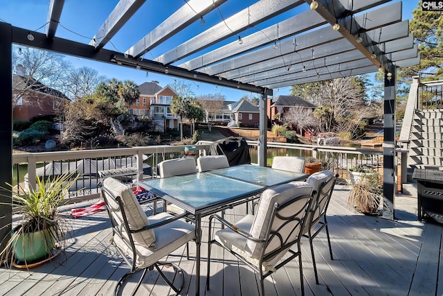 wooden deck featuring a pergola, outdoor dining area, and a residential view