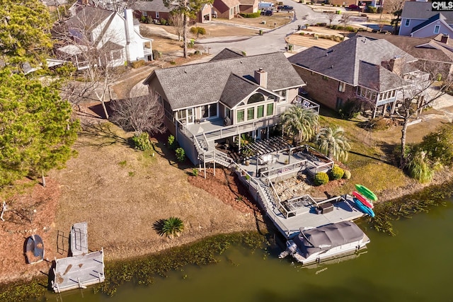 aerial view of residential area with a large body of water