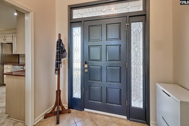 foyer with light tile patterned floors and baseboards