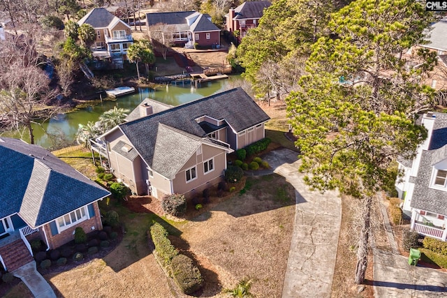 aerial perspective of suburban area with a nearby body of water