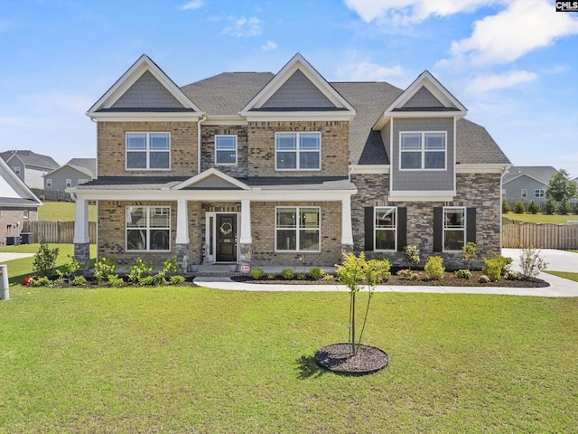craftsman-style house with stone siding and a shingled roof