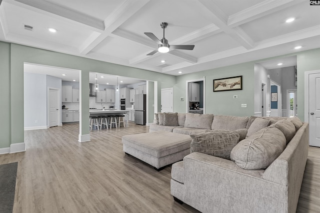 living room featuring coffered ceiling, ceiling fan, light wood-style flooring, beam ceiling, and recessed lighting