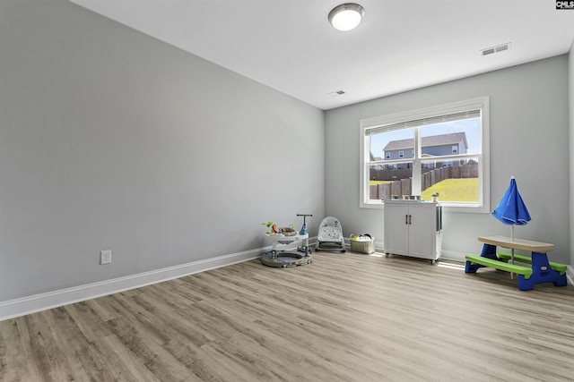 rec room with wood finished floors and baseboards