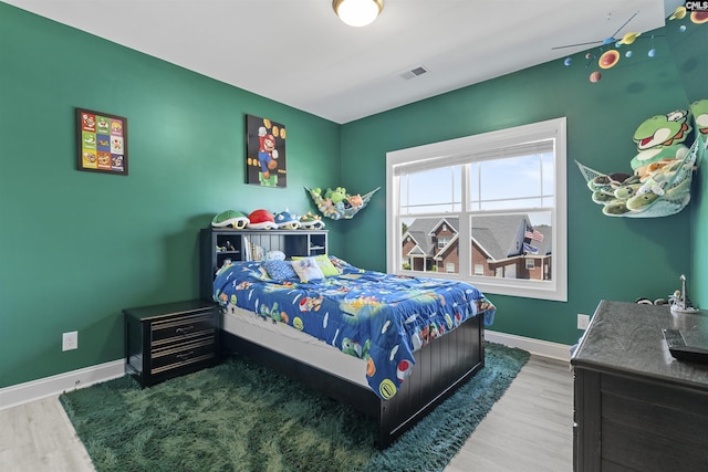 bedroom featuring wood finished floors and baseboards