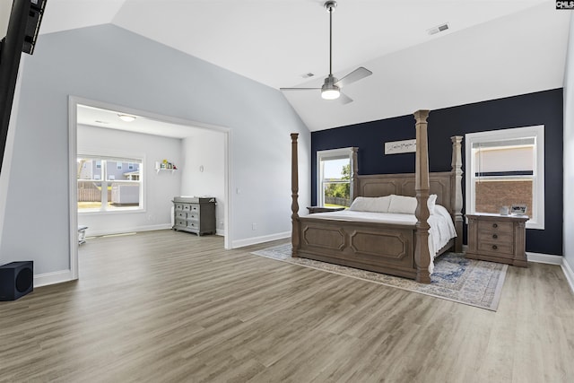 bedroom featuring vaulted ceiling, light wood finished floors, ceiling fan, and baseboards