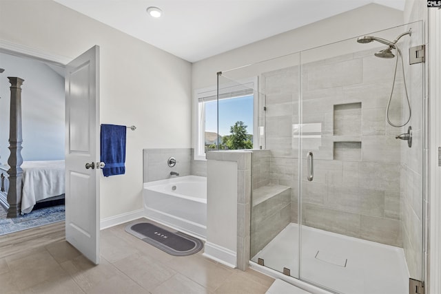 full bathroom with a stall shower, ensuite bathroom, a bath, baseboards, and tile patterned flooring