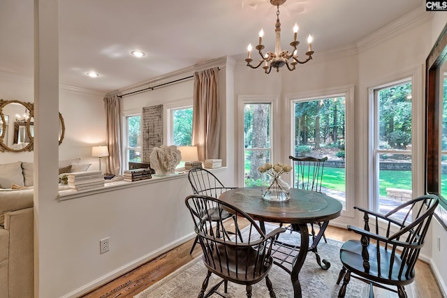 dining space featuring crown molding, a chandelier, light wood-style flooring, baseboards, and recessed lighting