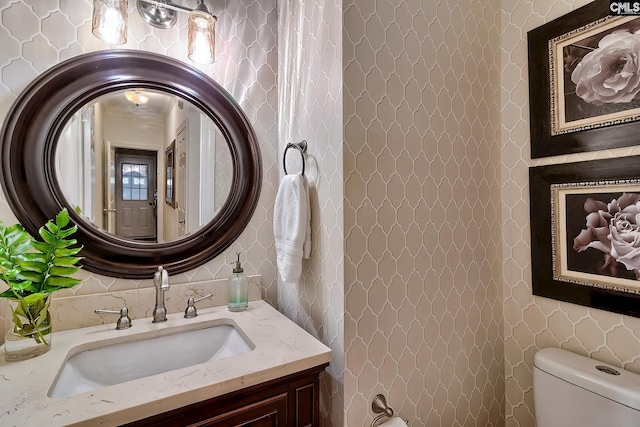 bathroom featuring toilet and vanity