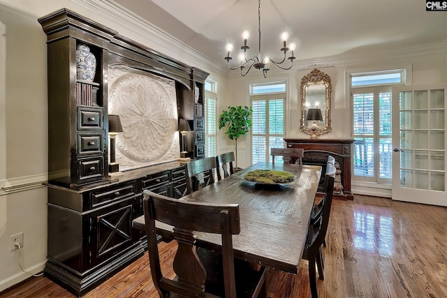 dining space with a chandelier, crown molding, and wood finished floors