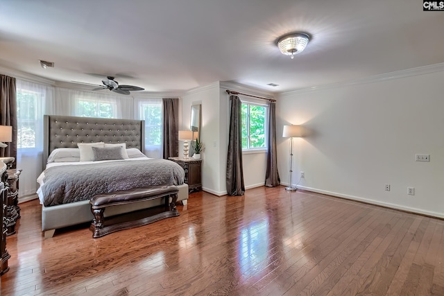 bedroom featuring ornamental molding, wood finished floors, baseboards, and ceiling fan