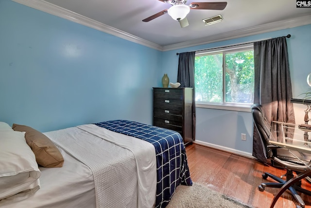 bedroom featuring wood finished floors, baseboards, ornamental molding, a desk, and ceiling fan