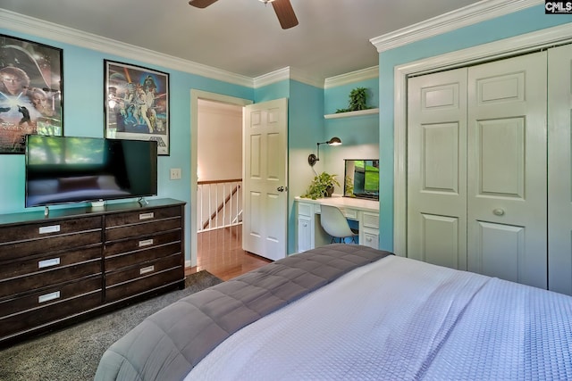 carpeted bedroom featuring a closet, ornamental molding, and a ceiling fan