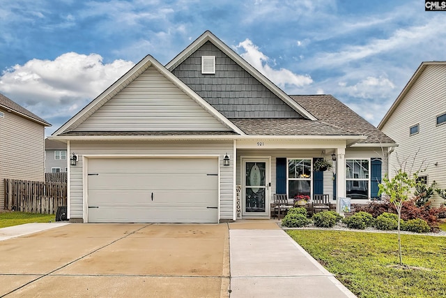 view of front of property with covered porch, driveway, and roof with shingles