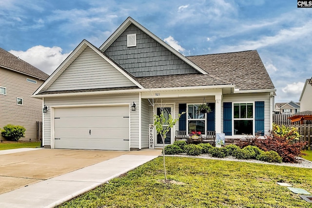 view of front of home with covered porch, driveway, a garage, and roof with shingles