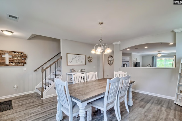 dining area with wood finished floors, a ceiling fan, recessed lighting, a chandelier, and arched walkways