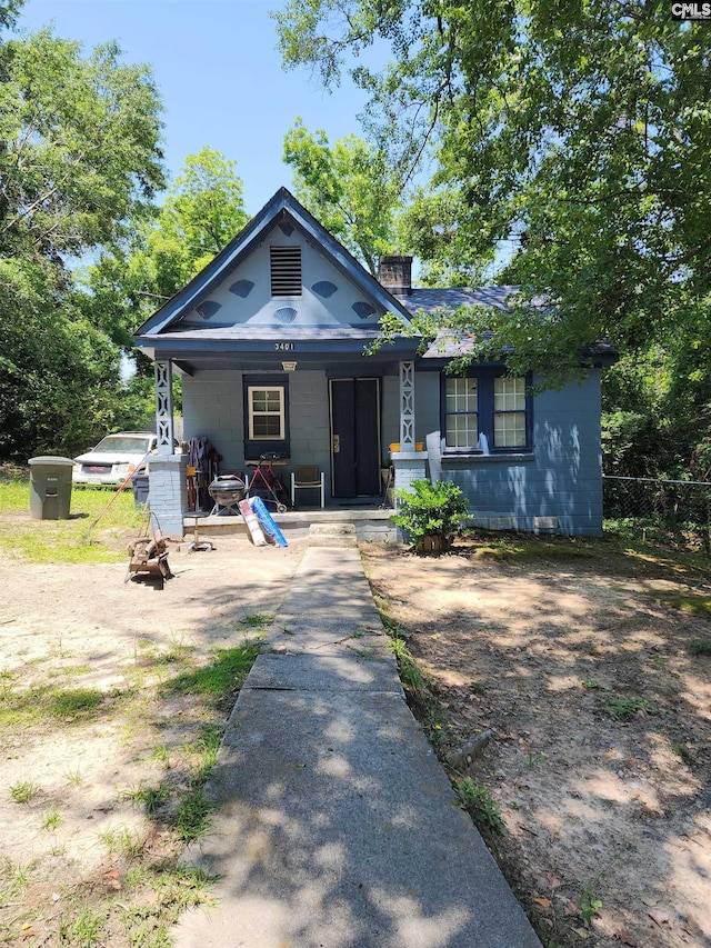 3401 Piedmont Ave, Columbia, SC 29203 - view of front of property featuring covered porch, concrete block siding, a chimney, and fence