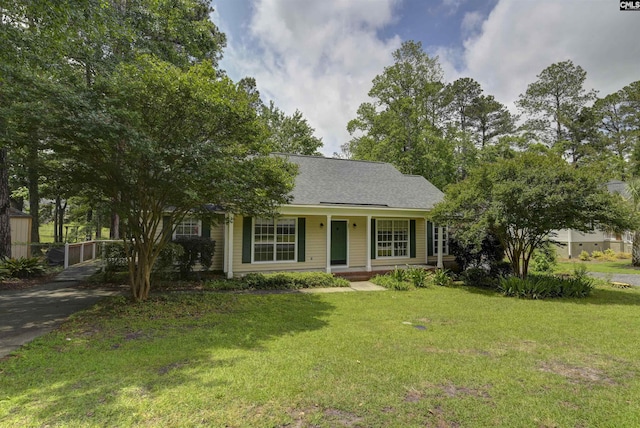 view of front of house featuring covered porch and a front lawn