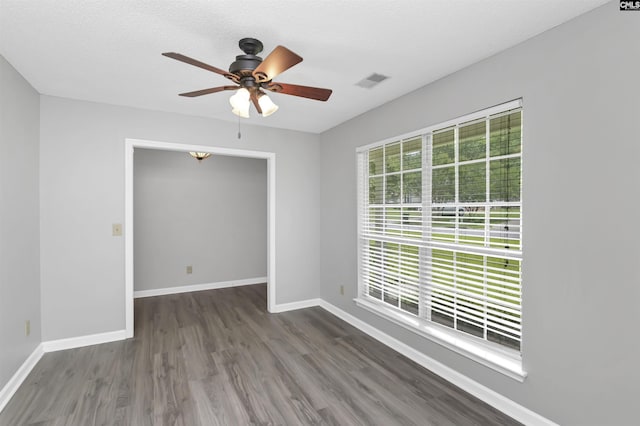 spare room with wood finished floors, baseboards, and ceiling fan