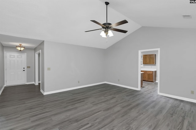 unfurnished living room featuring ceiling fan, dark wood-style floors, baseboards, and lofted ceiling