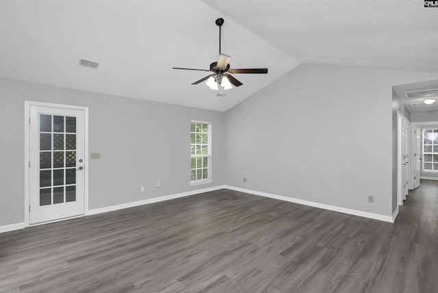 unfurnished living room featuring ceiling fan, lofted ceiling, dark wood-style flooring, plenty of natural light, and baseboards