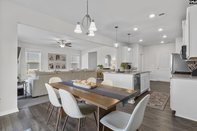 dining area featuring dark wood finished floors, ceiling fan, recessed lighting, a chandelier, and baseboards