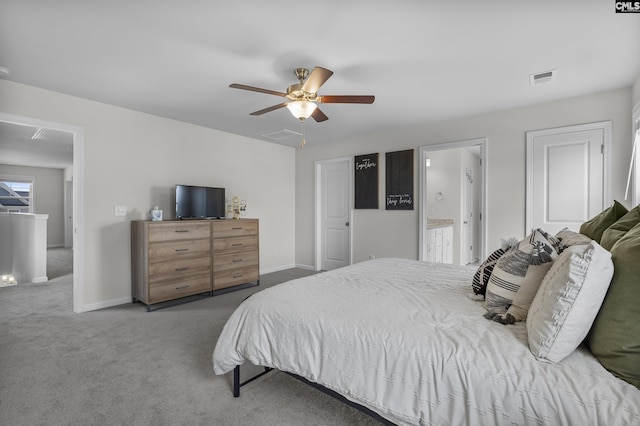 carpeted bedroom with ceiling fan, baseboards, and ensuite bath