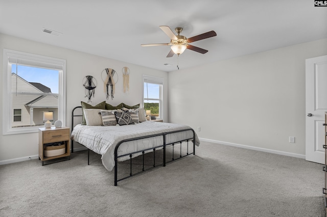 carpeted bedroom with baseboards and ceiling fan