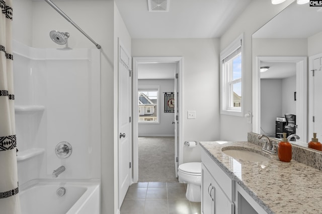 bathroom with toilet, tile patterned flooring,  shower combination, vanity, and baseboards