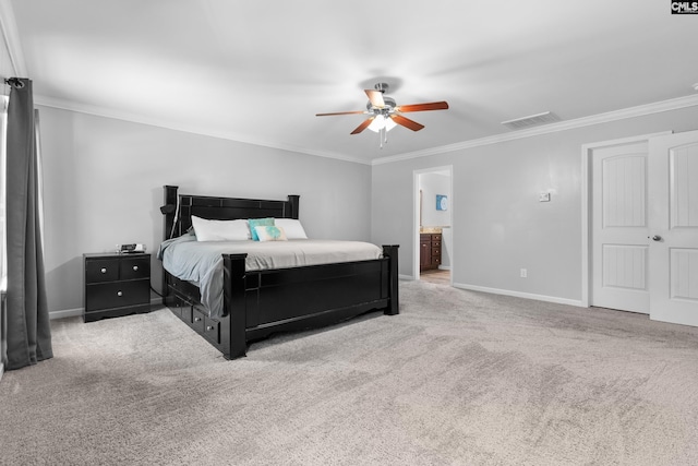 bedroom with crown molding, baseboards, carpet floors, and ensuite bath